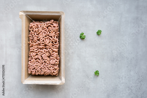 Minced plant-based meat in packaging on a gray background. photo