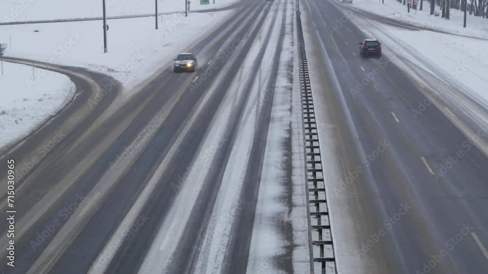 Traffic on highway during winter blizzard. Snowstorm on the road. Traffic on highway during winter blizzard. Snowstorm on the road.