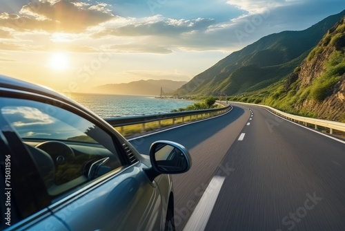 car driving on a highway. against the background of a mountain landscape, the sea and the shining sun. Travel, vacation, outdoor recreation, trip. © BetterPhoto