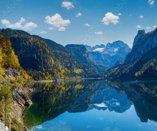 Fototapeta Naklejka Na Ścianę i Meble -  Peaceful autumn Alps mountain lake with clear transparent water and reflections. Gosauseen or Vorderer Gosausee lake, Upper Austria. Dachstein summit and glacier in far.