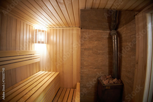 Interior of Finnish sauna, classic wooden sauna with hot steam. Russian bathroom.