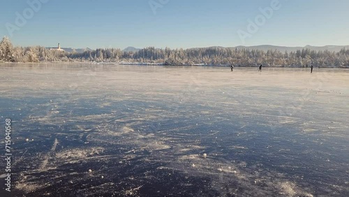 Ice skating on a frozen mountain lake in the Alps.