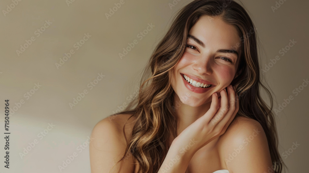 Smiling woman with a hand gently touching her face, displaying clear skin and a joyful expression. Smiling woman with a hand gently touching her face, displaying clear skin and a joyful expression.