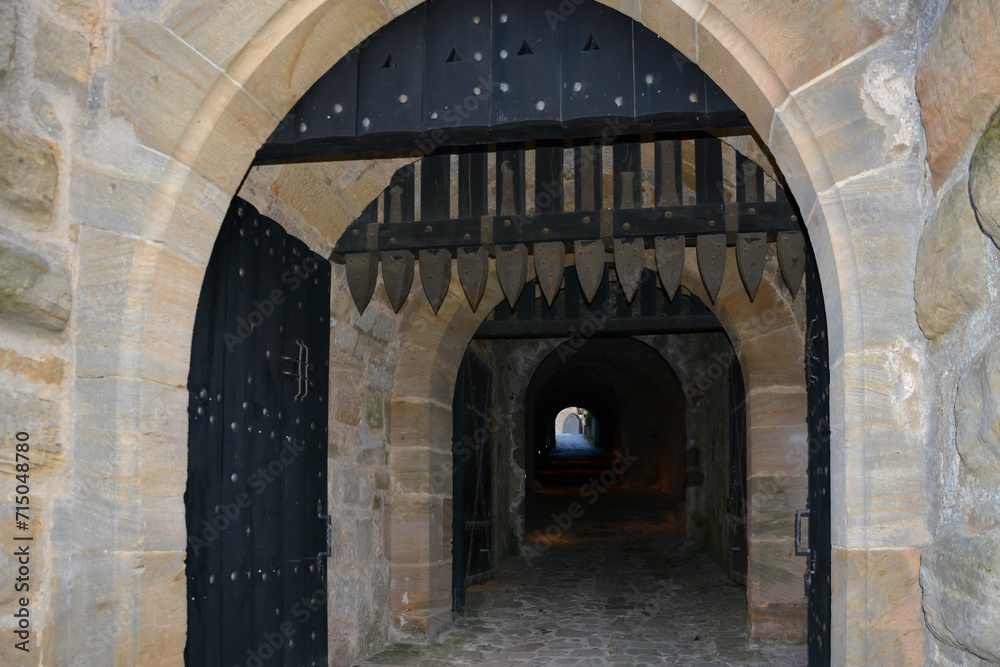 Exit from the courtyard through the gates of a medieval fortress in England, Great Britain. Interior and architecture