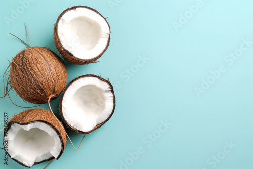 Top view of coconut isolated on blue background ripe coconuts. Top View. Copy Space. Pop art design, creative summer concept. Banner. Half of coconut in minimal flat lay style. Summer composition