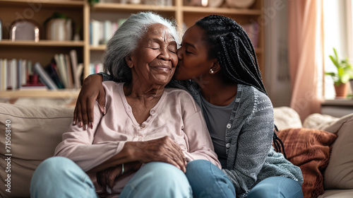 Young woman and an elderly woman are closely embracing