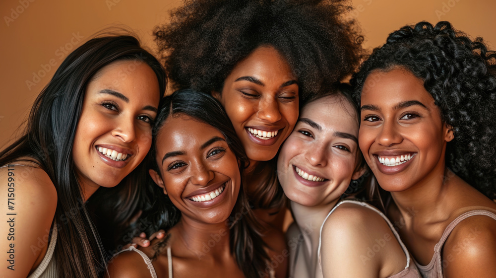 Smiling women are huddled closely together, portraying a warm, friendly, and diverse group. Smiling women are huddled closely together, portraying a warm, friendly, and diverse group.