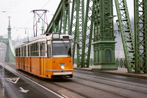 yellow tram on the Freedom Bridge in Budapest, public transport