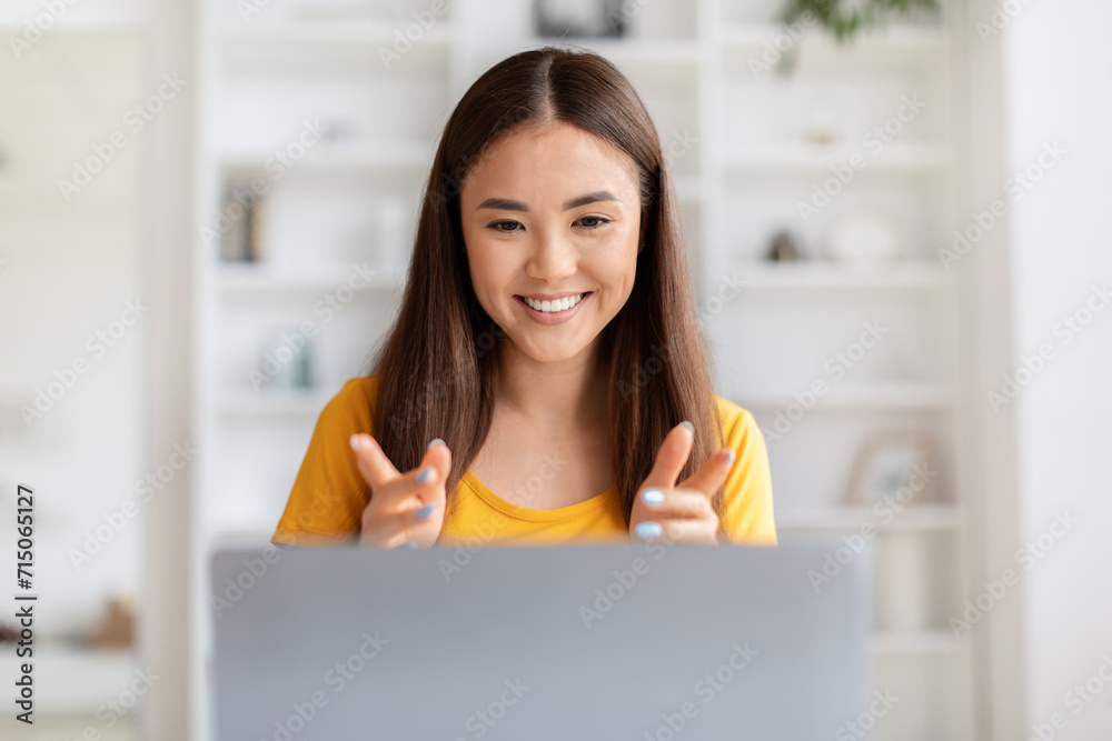 Beautiful young asian woman video calling on laptop at home office Beautiful young asian woman video calling on laptop at home office