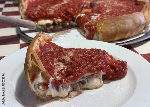 A slice of thick Chicago style pizza with sausage and pepperoni