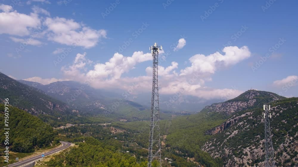 Drone shot of communication tower in rural mountains. Telecommunication tower with antennas. Wireless communication antenna transmitter Drone shot of communication tower in rural mountains. Telecommunication tower with antennas. Wireless communication antenna transmitter