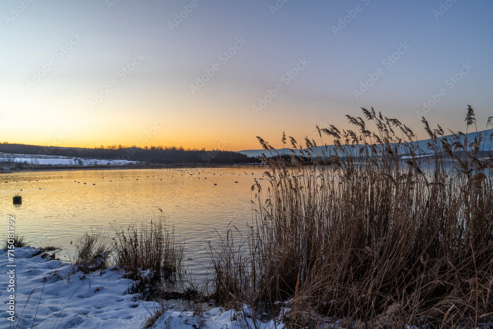 Milada lake with color frosty sunset and blue sky