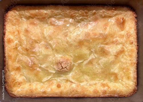 Homemade gooey butter cake deliciously golden and cracked on the surface photo
