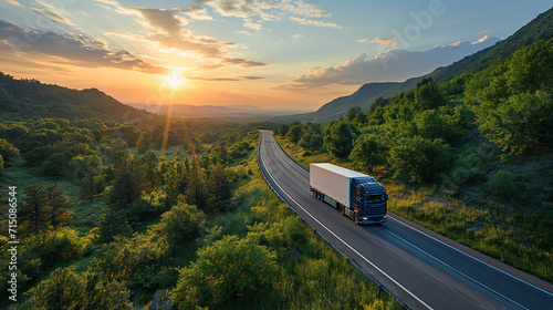 Truck driving through lush countryside at sunrise, warm golden light on the horizon, logistics transport, highway, scenic journey, freight delivery.
