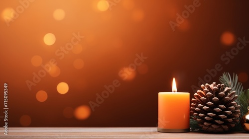  a lit candle next to a pine cone and a pine cone on a table with blurry lights in the background.