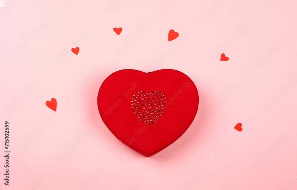 a red gift box in the shape of a heart on a pink background, surprise gift, concept of preparing gifts for celebrations, congratulations on Valentine's Day, happy birthday, mother's day