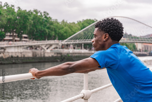 Urban Contemplation: Young African American by the Riverside © Ana Sofía