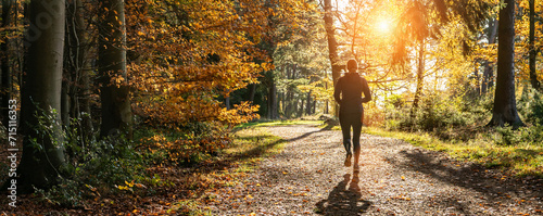 Obraz na płótnie Female Runner in Silent Forest in spring with beautiful bright sun rays w salonie