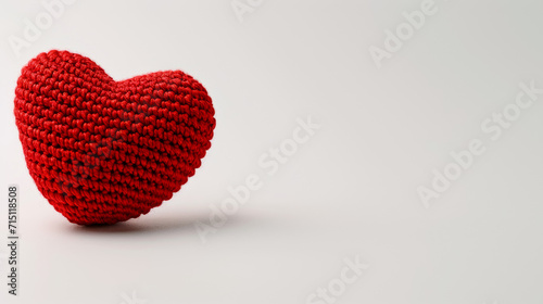 Amigurumi little heart. Handicraft cute Crocheted doll. Isolated on white background. Love symbol postcard, health concept or Valentine's day banner.