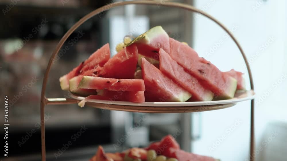 Catering service on banquet table with sliced fruits and watermelon on the table in restaurant or hotel. Decorated food set on birthday, wedding celebration or business conference event venue Catering service on banquet table with sliced fruits and watermelon on the table in restaurant or hotel. Decorated food set on birthday, wedding celebration or business conference event venue