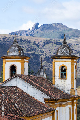 View of towers of historic baroque church Igreja Nossa Senhora das Merces e Perdoes, and mountains, Ouro Preto, Minas Gerais, Brazil photo