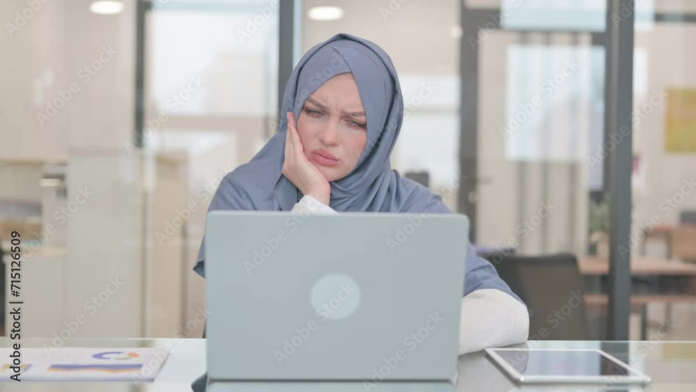 Arab Woman with Toothache Working on Laptop in Office Arab Woman with Toothache Working on Laptop in Office