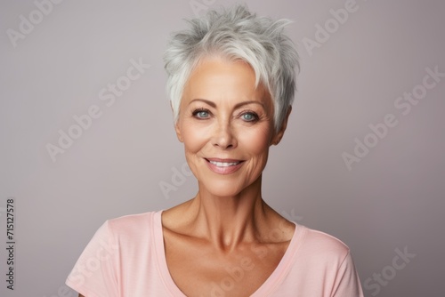 Portrait of a beautiful middle aged woman with grey hair looking at camera