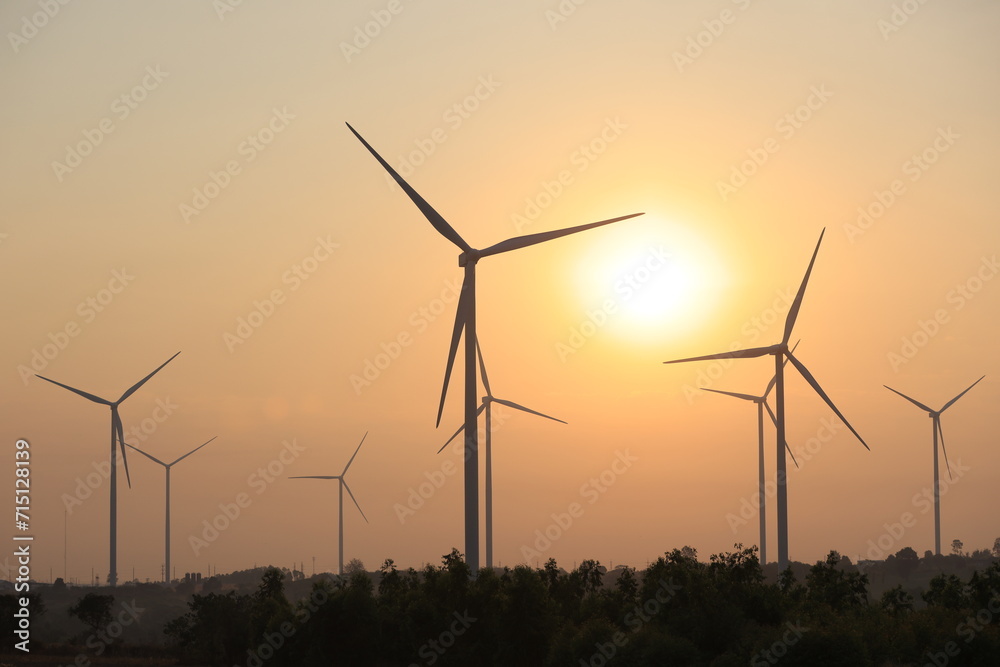 Silhouette windmill or Wind Turbine farm against rising sky, Eco green energy, renewable energy