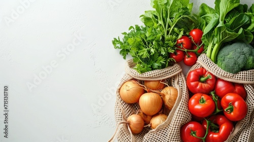 Fresh organic produce in a recyclable paper bag on a white background, concept of sustainable grocery shopping photo