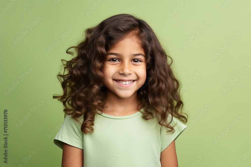 portrait of smiling little girl with long curly hair over green background portrait of smiling little girl with long curly hair over green background
