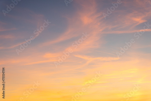 Sunset sky on twilight in the evening with orange gold sunset clouds. © Linas T