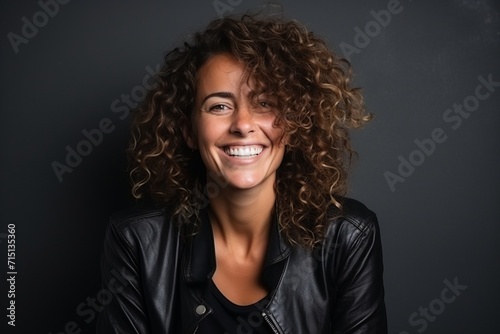 Portrait of a beautiful woman with curly hair smiling at the camera