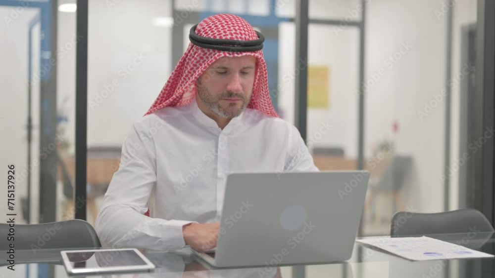 Arab Man Working on Laptop in Office