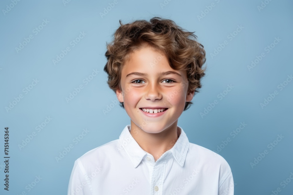 Portrait of a smiling little boy in a white shirt on a blue background Portrait of a smiling little boy in a white shirt on a blue background