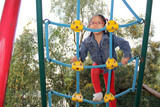 4-year-old Latin brunette girl plays in a playground, does physical activity as ADHD therapy, living in poverty
