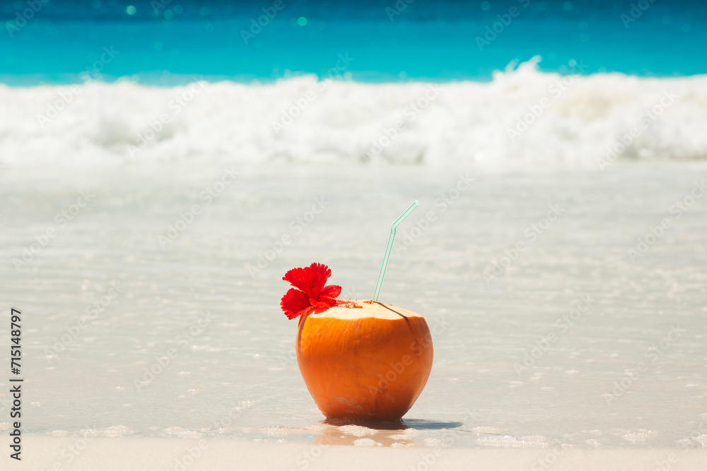 Tropical fresh coconut cocktail on white beach. Holiday and vacation concept. Tropical beach. Tropical fresh coconut cocktail on white beach. Holiday and vacation concept. Tropical beach.
