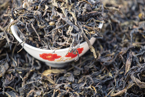 Dried green tea leaves in a bowl, for sale at the local market, Asia