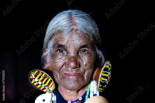 Portrait of old woman with tattoed face, Chin state, Myanmar photo