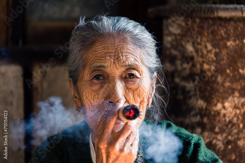 Portrait of old burmese woman smoking big cigar, Myanmar photo