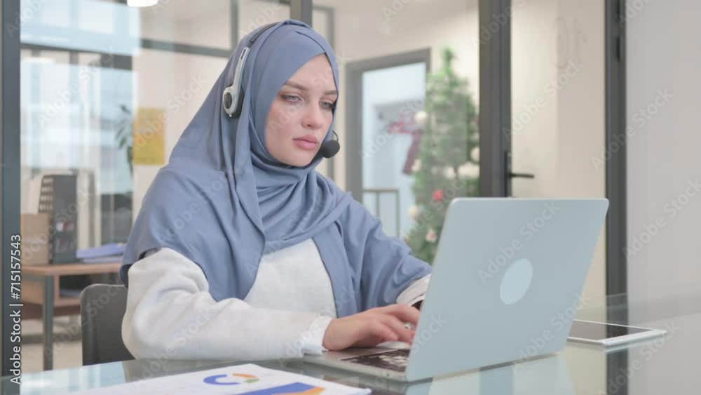 Woman in Hijab with Headset Working in Call Center Woman in Hijab with Headset Working in Call Center