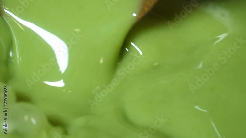 초록빛의 미나리 막걸리를 국자로 잘 섞어 막걸리잔에 담는 모습 photo