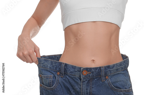 Slim woman wearing big jeans on white background, closeup. Weight loss
