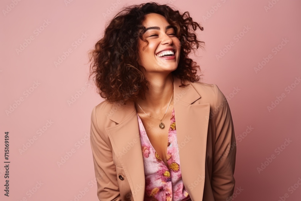 Portrait of a beautiful young african american woman laughing against pink background Portrait of a beautiful young african american woman laughing against pink background