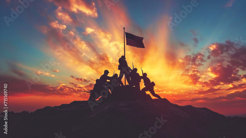 Silhouettes of soldiers raising a flag on a hill, against a dramatic sunset, evoke the iconic Iwo Jima scene representing sacrifice and victory. photo