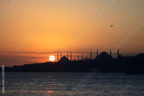 View of Istanbul's historical peninsula at sunset. View of the Sultanahmet Mosque located on the historical peninsula in silhouette.