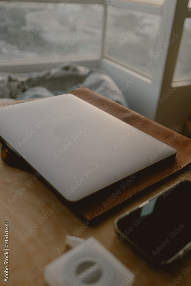 Fototapeta premium Computer laptop and mobile phone work set on wooden table in concept of home office freelance and entrepreneur.