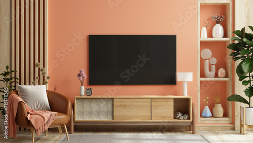 фотографія Mockup a TV wall mounted in pastel tone peach fuzz color wall