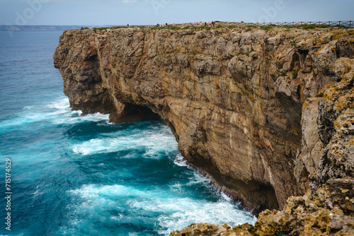 Spectacular view of rocky cliffs and Atlantic ocean with clear sky in the background.