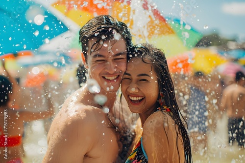 A joyful couple drenched in water, celebrating the vibrant and spirited Songkran Festival © Rax Qiu