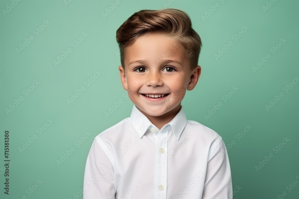 Portrait of a cute little boy in a white shirt on a green background Portrait of a cute little boy in a white shirt on a green background